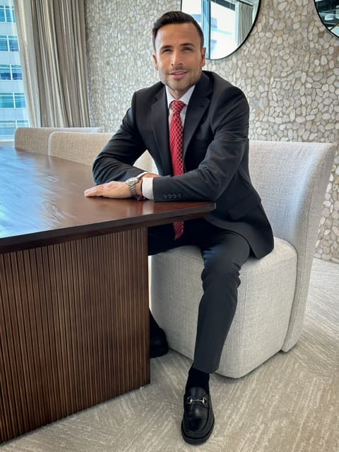 A man sitting at the table in front of a wall.